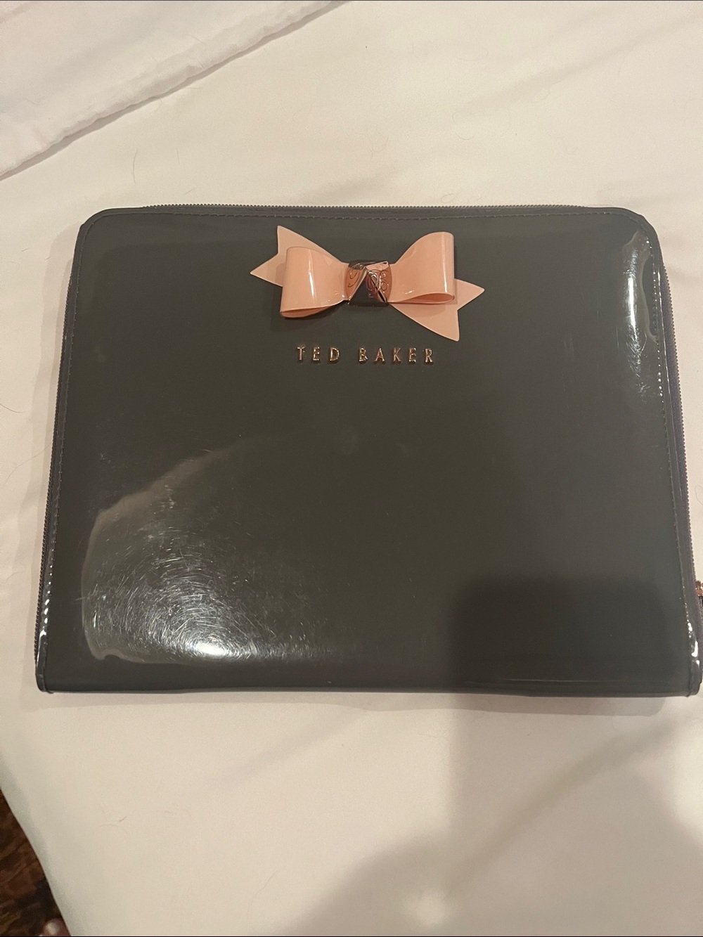 Ted Baker Black Patent Zip Case with Blush Bow Accent